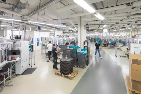 Mehrere Mitarbeitende in der Produktionshalle
